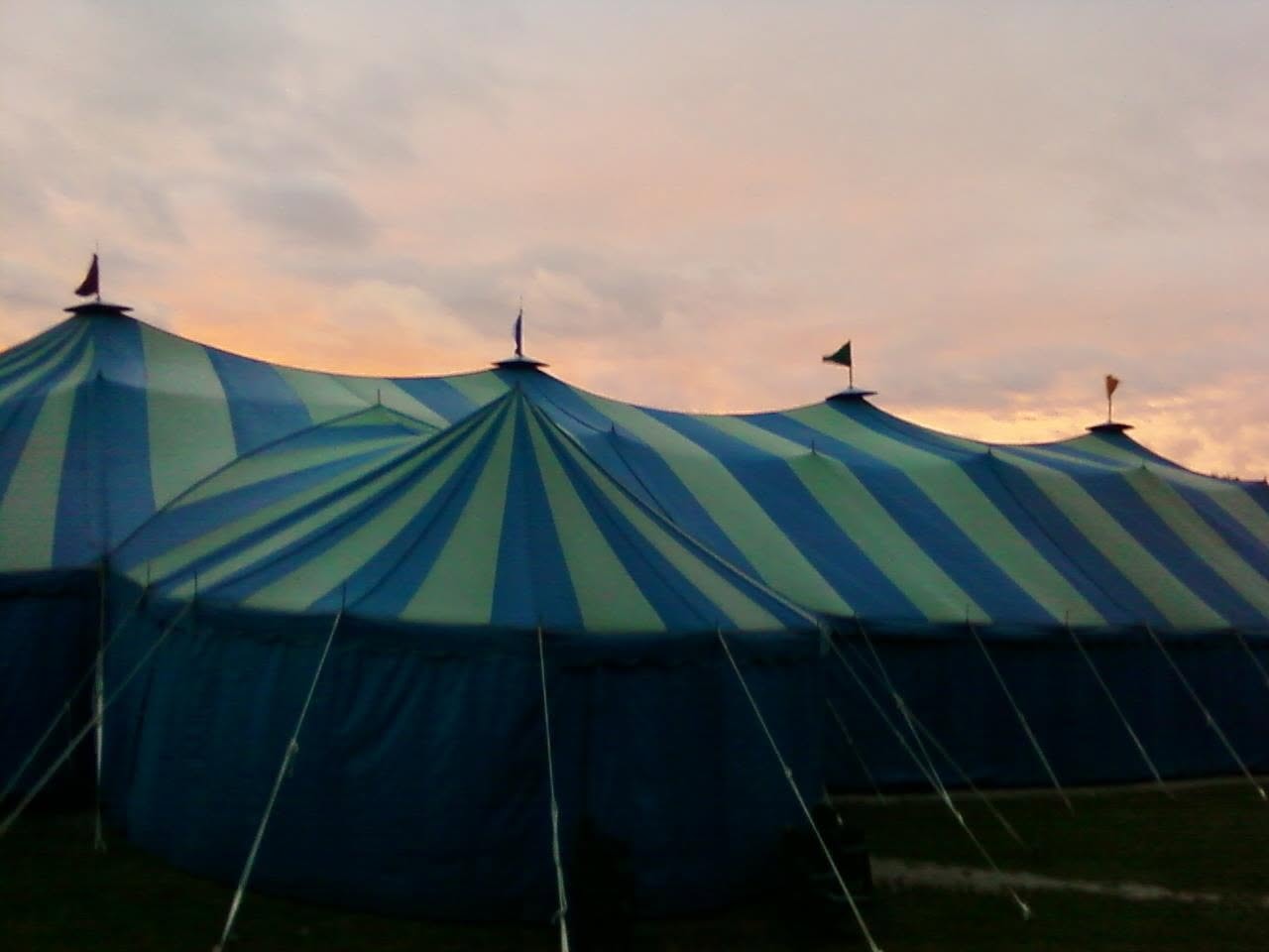 Big Top Chautauqua striped tent at sunset