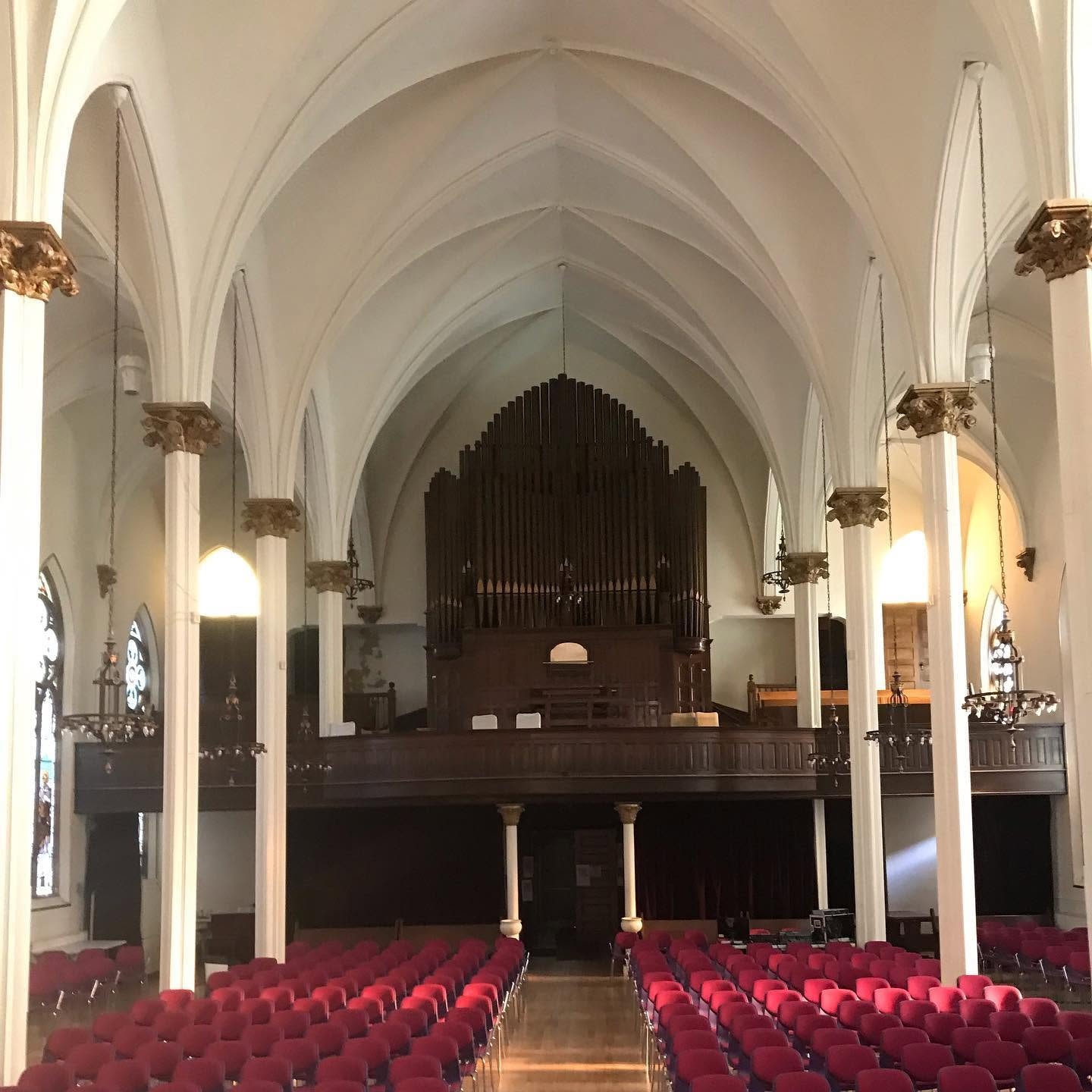 Sacred Heart church interior with vaulted ceilings and pipe organ