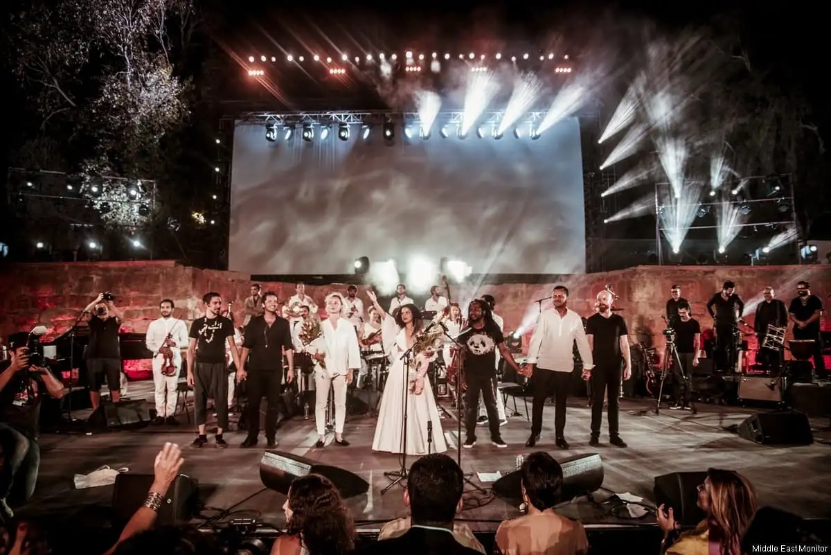 Emel Mathlouthi and her ensemble on stage in Tunis